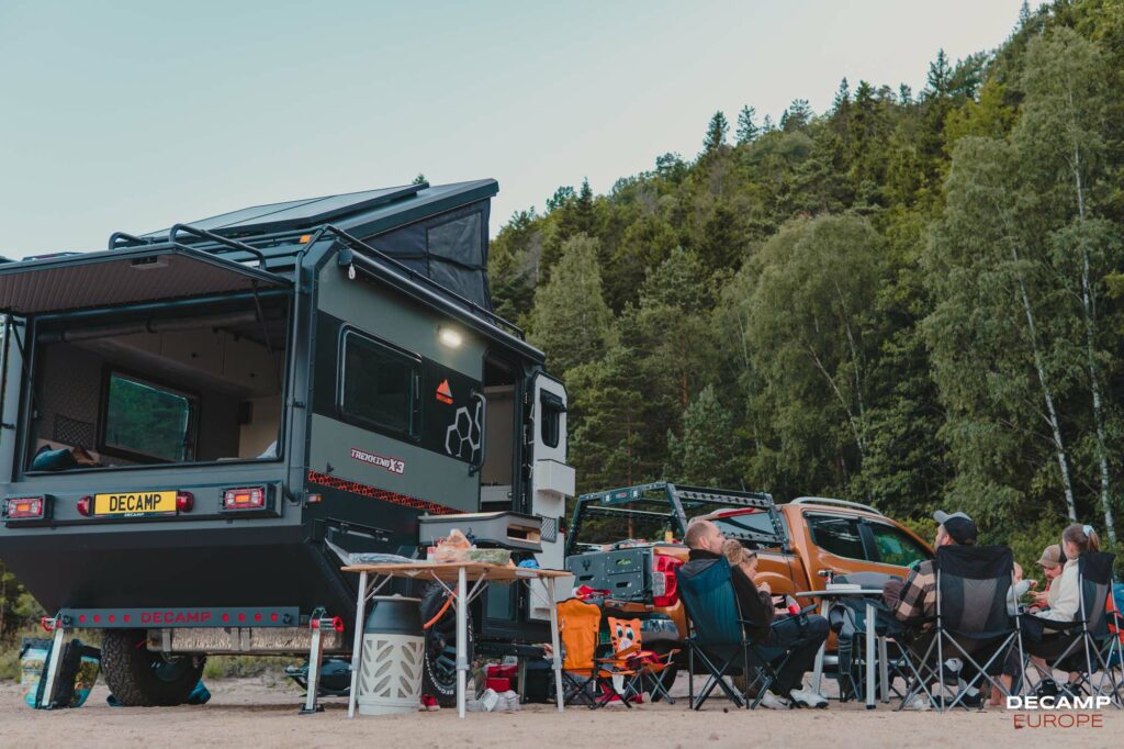 campement avec une caravane off road decamp x3 et un 4x4 orange